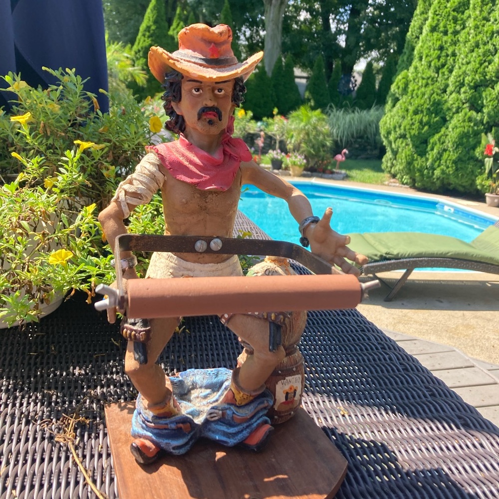 Novelty resin cowboy with his pants down toilet paper holder